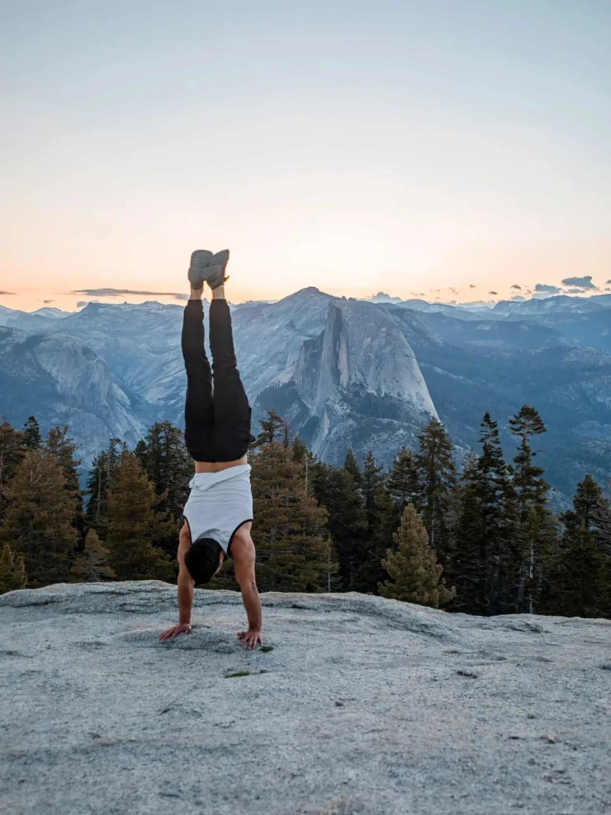 man doing handstand in athleisure wear